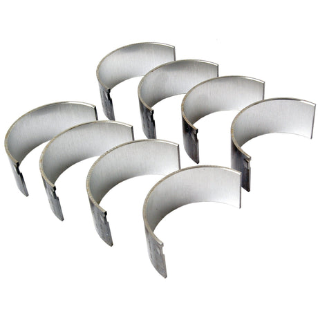 A set of seven silver metal semi-circular Conrod Bearings in a staggered formation, ideal for machinery from brands like David Brown or Case IH. Product: Conrod Bearing +0.010'' (0.25mm) Set | Sparex Part No.S.75989 from Sparex.