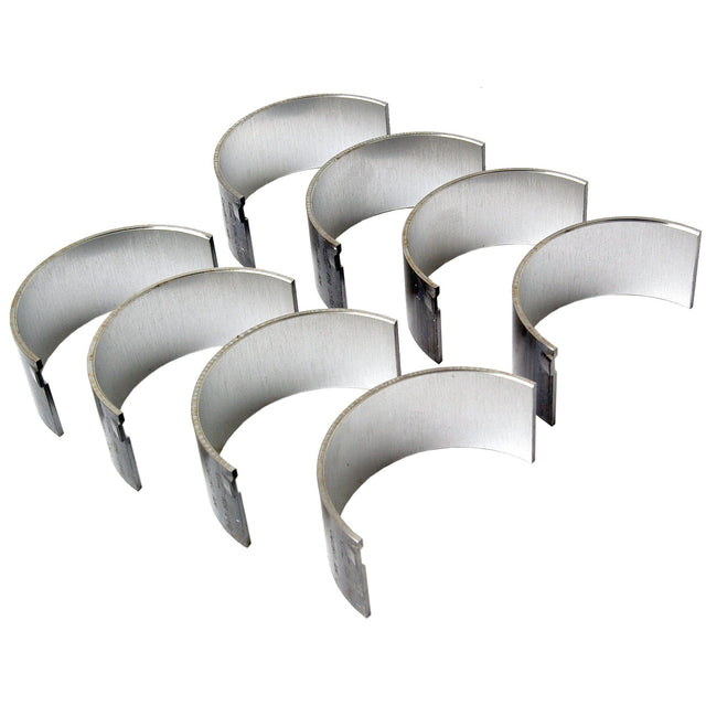 Seven semi-circular metal bearings, known as the Conrod Bearing +0.010'' (0.25mm) Set (Sparex Part No.S.75989), are arranged in a staggered formation against a white background, reminiscent of components used in David Brown tractors and Case IH machinery by Sparex.