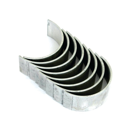 A set of seven Sparex Conrod Bearings +0.020'' (0.50mm) (Sparex Part No.S.66074), essential engine parts compatible with Ford / New Holland models, arranged in a row on a white background.