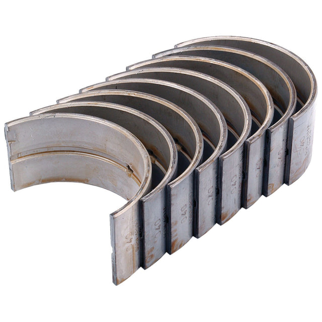 A set of eight semi-circular metal engine bearings, perfect for Ford New Holland models, are arranged in a row. They are named "Conrod Bearing +0.040'' (1mm) Set | Sparex Part No.S.65208" and are produced by the brand Sparex.