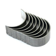 The Conrod Bearing Std. Set (Sparex Part No. S.40319) from Sparex features eight metallic engine bearings, compatible with Massey Ferguson or Ford New Holland models, arranged in a curved, overlapping formation.