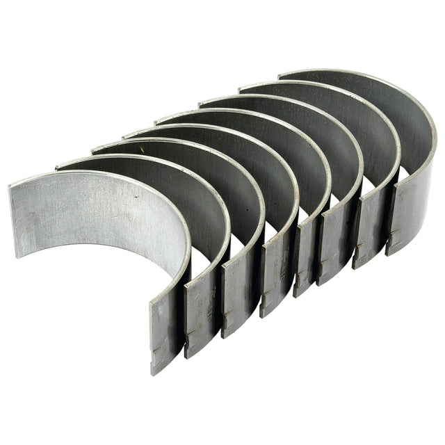 A set of seven silver Conrod Bearing Std. Set - S.52617 from Sparex, perfect for tractor tube repair, aligned in a row on a white background.