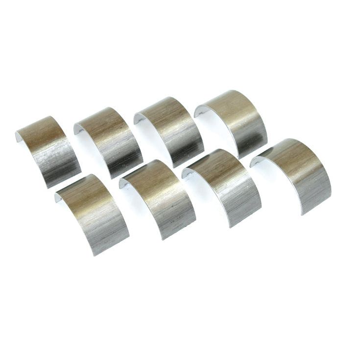 Eight silver-colored metallic bearing shells, arranged in two rows on a white background, suitable for Ford / New Holland machinery. Presenting the Conrod Bearing Std. Set | Sparex Part No.S.65189 by Sparex.