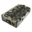 Image of a Cylinder Head Assembly - S.40304 by Sparex with valves and springs visible, displaying metallic surfaces and multiple drilled holes; compatible with Perkins Engines and various tractors.
