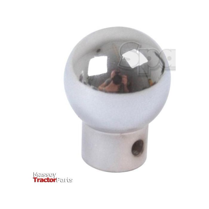 A silver, spherical gear shift knob with a small hole at the base. The background shows a blurred image and text "Massey Tractor Parts." Perfect for models like the Massey Ferguson TE20 or those equipped with part number 180006M91. This product is listed as Gear Knob | Sparex Part No.S.43765 by Sparex.