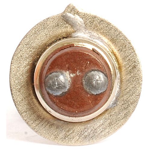 Close-up view of the contact tip of a welding electrode, featuring a circular, metallic surface with two raised, soldered points, reminiscent of the precise terminals found on Sparex's 12V 25W light bulb (Filament) PX15d (Box 1 pc.), Sparex Part No.S.54977.