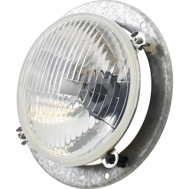 Close-up image of the round, clear, ridged headlight with a metal mounting bracket, featuring a sleek design by Sparex. Product name: Head Light, (Halogen), RH & LH, RH Dip, 12V - S.75956.