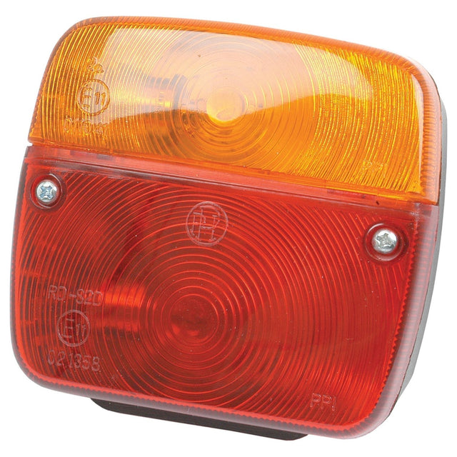 A close-up image of the Halogen Rear Combination Light 12V, RH & LH - S.12063 by Sparex, featuring a rectangular tail light with an amber lens on top and a red lens on the bottom, secured by two screws. The IP65-rated design ensures durability, making it perfect for various conditions.
