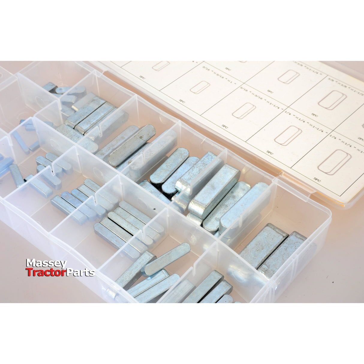 A plastic organizer with multiple compartments filled with various sizes of metal parts labeled as Imperial Parallel Keys Assortment, 60 pcs. Compak (Sparex Part No. S.29902). The background shows a paper template with outlines of the parts and the "Massey Tractor Parts" logo is visible.