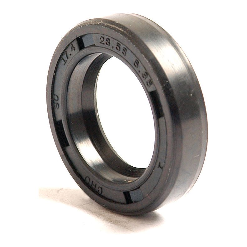 Close-up of a black rubber Imperial Rotary Shaft Seal, 11/16'' x 1 1/8'' x 1/4'' (Sparex Part No. S.4433), with engraved specifications on its surface, compatible with Ford/New Holland machinery.