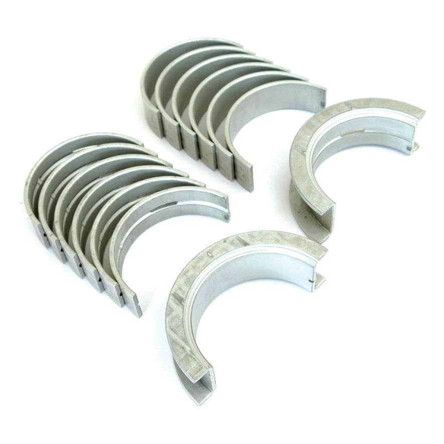 Image of several metallic engine bearings arranged in two groups. The half-circle shaped Main Bearing +0.020'' (0.50mm) (Set), compatible with Sparex and Case IH equipment, appear clean and unused. The product is identified as Sparex Part No.S.57664.