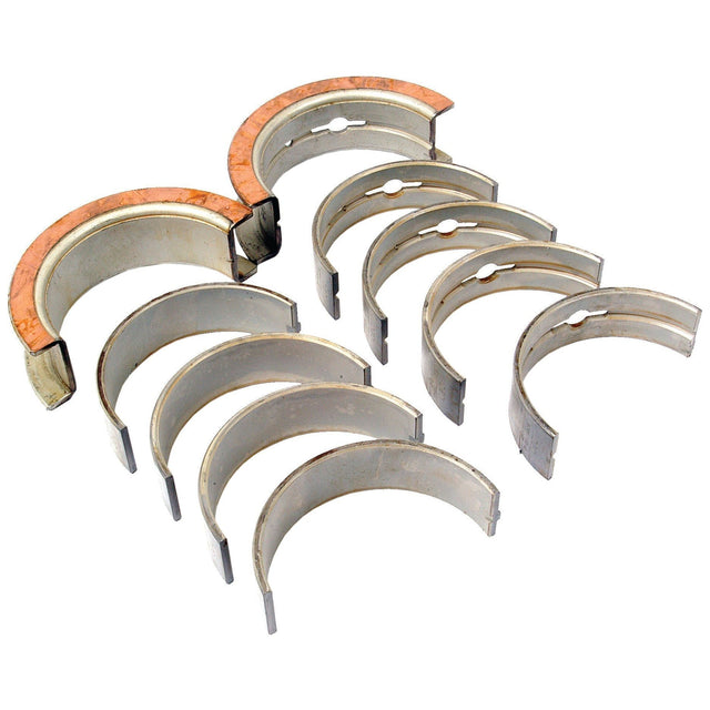 The Sparex Main Bearing +0.020'' (0.50mm) set (Part No.S.66530) consists of ten metal half-cylinder engine bearings, arranged in two parallel rows, with some bearings in the upper row featuring copper-colored backing, specifically designed as a main bearing replacement for Ford / New Holland tractors.