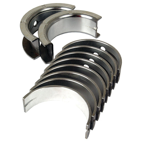 A set of metallic Sparex Main Bearing Std. (Set) | Sparex Part No.S.57655 arranged in two rows with several individual pieces showing their curved shape and inner linings, suitable for International Harvester models.