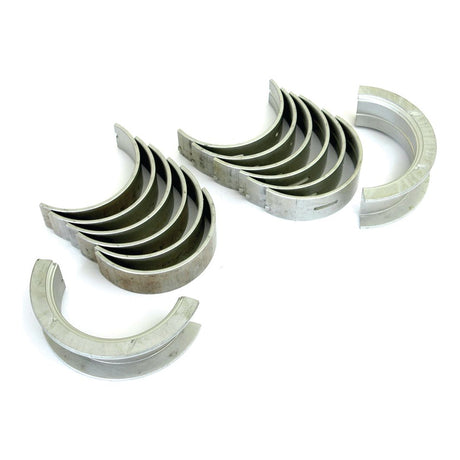 A set of Sparex Part No.S.66035 Main Bearing Std., arranged in two curved stacks, shown on a white background—perfect for Ford / New Holland models.