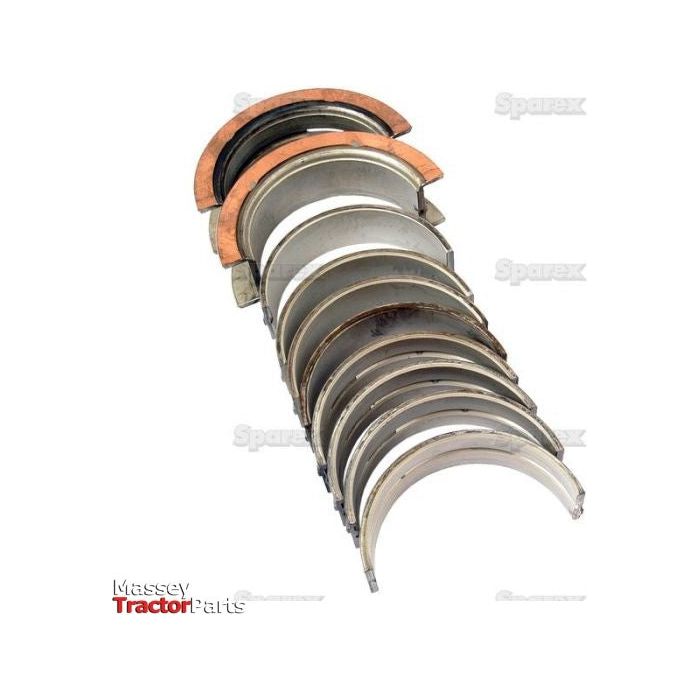 A set of Main Bearing Std. (Set) | Sparex Part No. S.66528 engine bearings are arranged in a row. These metal bearings show some signs of wear. The image background is white, with the "Massey Tractor Parts" text visible at the bottom left. Some components are compatible with Case IH and Ford New Holland tractors, highlighting their versatility from the Sparex brand.