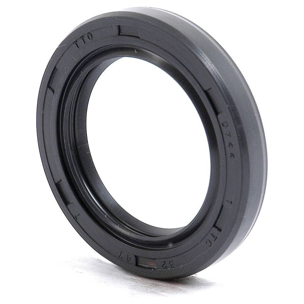 A Sparex Metric Rotary Shaft Seal (Part No. S.50256), black and rubber, with a circular shape and 32 x 47 x 7mm dimensions, featuring inscriptions on its outer edge, rests upright on a flat surface. The seal boasts a durable double lip design.