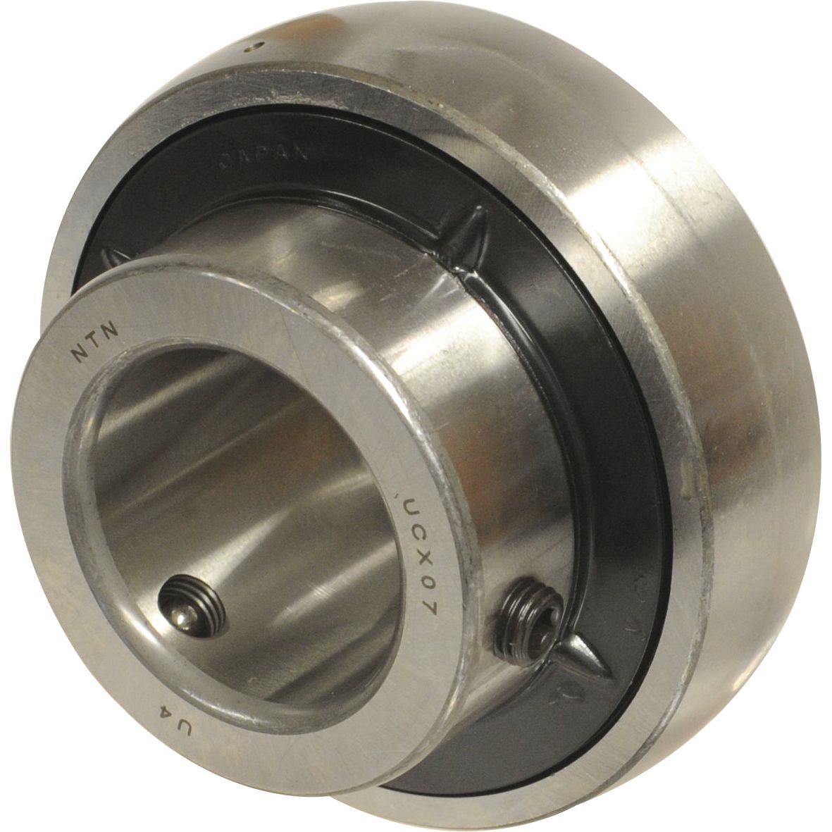 A Sparex NTN SNR Plummer Block Bearing Insert (UCX13-40) - S.129721 featuring a metallic construction with a central circular hole, visible engravings on its surface, and detailed manufacture information.