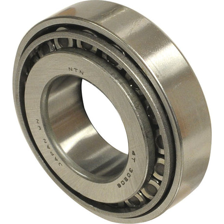 Close-up of a metallic cylindrical roller bearing, specifically an NTN SNR Taper Roller Bearing (30209) - S.129557 by Sparex, with visible rollers and etched text on the outer and inner rings.