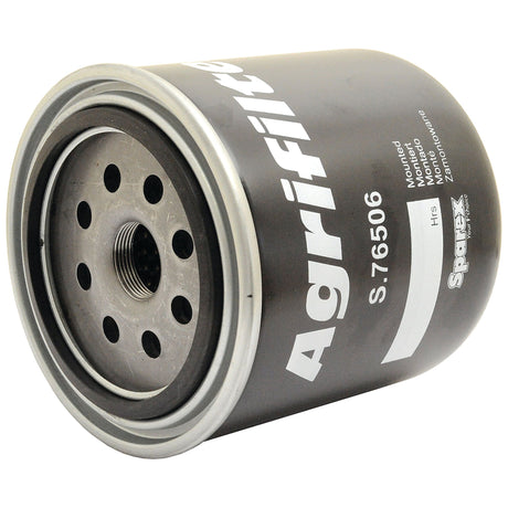 A cylindrical oil filter, labeled "Oil Filter - Spin On | Sparex Part No.S.76506," features multiple holes on the top face and manufacturer's information, including compatibility with Ford New Holland, printed on the side.