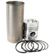 A Piston Ring and Liner Kit (Sparex Part No. S.40454), consisting of a metal cylinder liner, a Perkins piston with a circular recess on top, and seven Sparex piston rings, laid out in front of them.