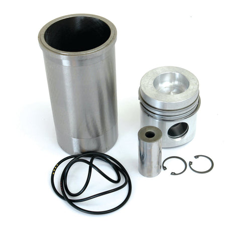 A Piston Ring and Liner Kit by Sparex (Part No. S.37845), including a Case IH / International Harvester cylinder sleeve, chrome-plated keystone piston, piston pin, two snap rings, and three piston rings arranged on a white surface.