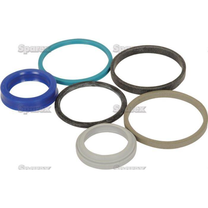Five seals and gaskets of different sizes and materials are arranged on a white background, featuring blue, green, grey, and black rings used in Power Steering systems for Case IH equipment. These components are part of the Seal Kit (Power Steering) from Sparex, identified by Part No. S.65092.