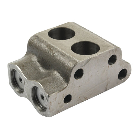 A Valve Chamber (Sparex Part No. S.40847), a silver metal component with multiple circular holes and openings, exhibiting signs of wear and slight discoloration, reminiscent of vintage MKII Pumps.