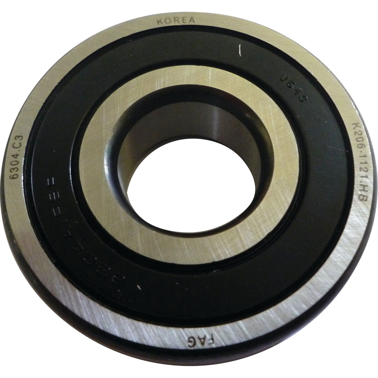 Close-up of a metallic ball bearing with the words "KOREA" and "6304 C3" engraved on it. The Spigot Bearing - S.146128 from Sparex features a black inner ring, visible grooves, and precise dimensions of 20mm x 52mm.