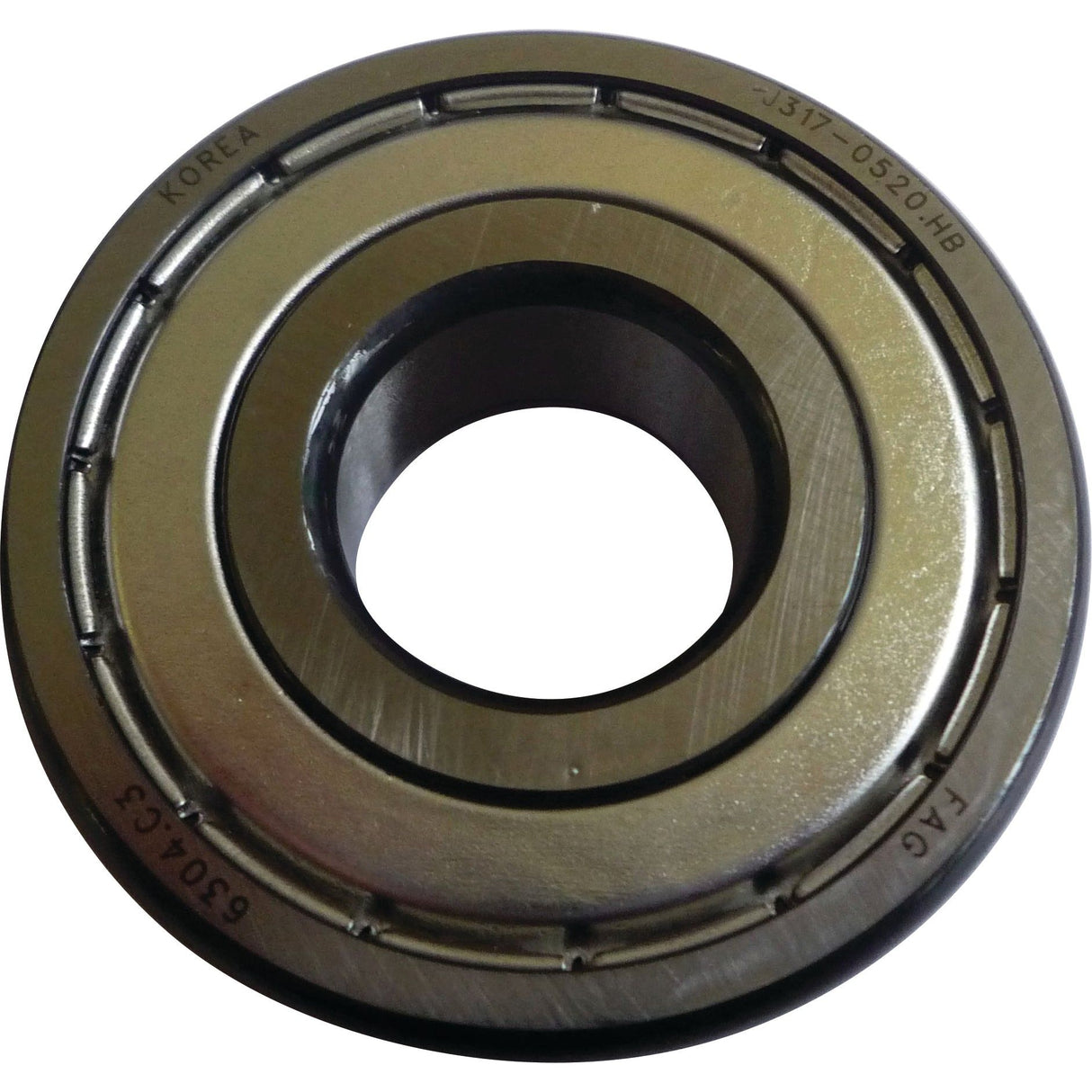 Close-up of a metallic bearing ring with markings, including "Korea" and various serial numbers, engraved on its surface. The object features inner and outer circular tracks, reminiscent of the precision found in high-quality machinery like Sparex's Spigot Bearing - S.146129.