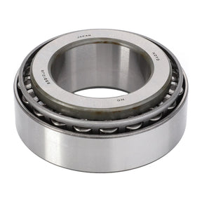 A close-up image of the Massey Ferguson - Bearing Assy - 005103691, featuring a metallic outer and inner ring designed for high-load applications. The visible rollers in the gap between the rings highlight precision engineering and reliability comparable to AGCO’s renowned Dyna-6 transmission systems.