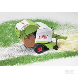 A green and white Claas round baler - U02121 from Bruder is positioned on a grassy surface, with a round hay bale being produced at the rear. This detailed 1:16 scale model showcases the precision and craftsmanship of the original Claas equipment.