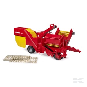 A Grimme potato digger - U02130 from Bruder, featuring a red and yellow design, likely representing a model harvester. This 1:16 scale agricultural vehicle intricately blends metal and plastic elements, with detailed components and two metal grid pieces placed on the side.