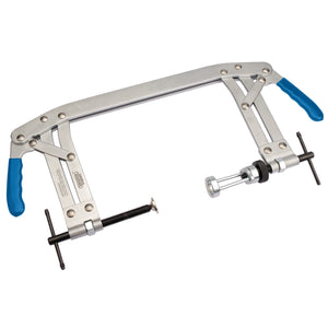 The Draper Expert Universal Valve Spring Compressor, 55 - 175mm - VSC11 by Draper features blue locking handles and adjustable screws on both ends, designed for compressing or removing valve springs in engines.