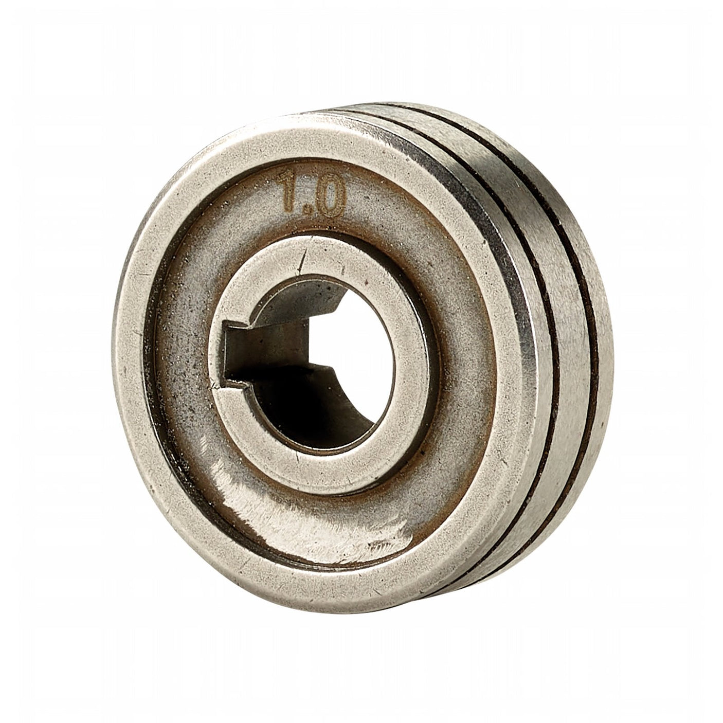 The Draper Mig Welder Wire Feed Drive Roller, 1.0-1.2mm - AMI200A-12, is a metal circular component with a central hole and keyway, marked with "1.0". Its outer surface features four concentric grooves, similar to those found on wire feed drive rollers used in MIG welders.