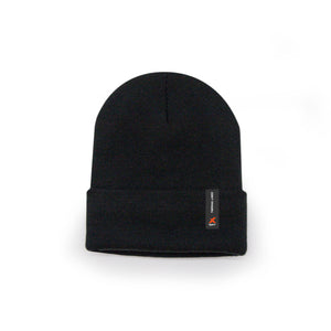 The Xpert Core Thermal Lined Beanie Hat Black by Cottonmount features a small tag with an orange hat logo and white text on the folded rim, offering extra warmth with its cozy fleece lining.