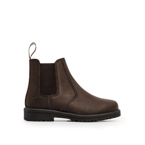 The Xpert Heritage Wrangler Junior Dealer Boot in Dark Brown by Cottonmount, featuring elastic side panels, a pull tab at the heel, a cushioned footbed for added comfort, and a black rubber sole, is displayed against a white background.