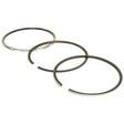 Three metal piston rings, with one fully intact and two open-ended, arranged side by side against a white background. These components include the Sparex Piston Ring (Sparex Part No. S.110975), commonly used in Case IH Models and Sisu Engines.