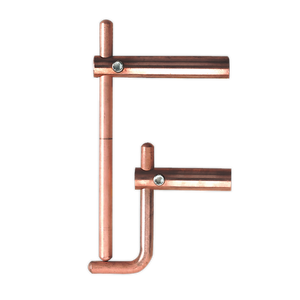 Copper pipe fittings arranged to resemble the letter "F", positioned alongside a sturdy Sealey Spot Welding Arms 120mm Exterior Profiles - 120/803158.