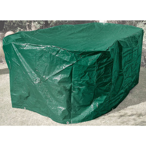 A Draper Oval Patio Set Cover, measuring 2300 x 1650 x 900mm and made of heavy-duty polyethylene, covers an object in a yard, amidst a sparse background of plants and grass.