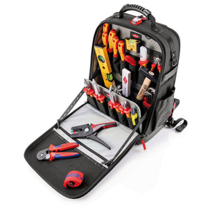 The Draper Knipex 00 21 50 E Tool Backpack Modular X18 Electro features a sleek black design with multiple compartments. It showcases tools like pliers, screwdrivers, a level, and measuring tape. The front panel opens to reveal the organized interior with MOLLE webbing for added versatility.