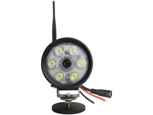 A round security camera integrated with six LED lights, an antenna, and exposed wires at the back, utilizing 2.4GHz wireless digital technology to enhance night vision capabilities, known as the LED Work Light with built-in Camera by Sparex (Sparex Part Number: S.162182). It operates within a voltage range of 10-32V.