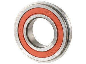 Close-up of a deep groove ball bearing with a red rubber seal, showing metal surfaces and engraved text indicating manufacturing details, branded as NTN SNR Deep Groove Ball Bearing (63062RSNRC5) and associated with Sparex Part Number: S.164840.