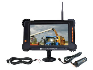 The MachineCam Mobility HD - Monitor Kit (Sparex Part Number: S.165292) from Sparex features a 7" monitor screen displaying a farm vehicle loading grain into a truck, with connected cables and a 12V port adaptor ensuring seamless operation.