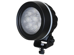 The Sparex LED Work Lights – High Power LED (S.169590) features a round, black design with a textured lens and includes a mounting bracket at the bottom. With 15300 lumens of raw power output and operating within 10-30V, this CE-approved light ensures reliability and performance while offering asymmetric interference protection classified at Class 3.