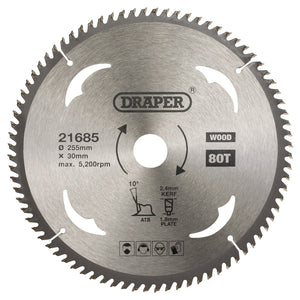 A close-up of the Draper Tct Circular Saw Blade For Wood, 255 x 30mm, 80T - SBW15. The chrome-plated blade is labeled with specifications including the brand "Draper" and details such as a 255mm diameter, tempered for durability, and a maximum speed of 5200 RPM.