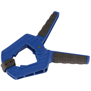 The Draper Soft Grip Spring Clamp, 70mm Capacity - D209, is a blue plastic clamp with heavy duty polypropylene construction. It features soft grip handles and a swiveling black gripping jaw for precise clamping.