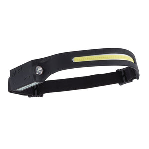 The Draper Cob Led Rechargeable 2-In-1 Head Torch With Wave Sensor, 3W (HT-350) features a sleek black curved bar design with both a main LED light and a yellow strip light. It attaches to an adjustable headband equipped with a buckle for secure fitting and includes a USB-C rechargeable battery for added convenience.