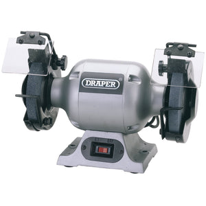 The Draper 230V Heavy Duty Bench Grinder, 150mm, 370W (GHD150) from Draper features dual grinding wheels, protective shields, and an on/off switch mounted on a sturdy base, making it ideal for any industrial workshop.