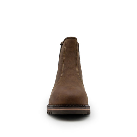 Front view of a single brown leather Xpert Heritage Boulder Non-Safety Boot by Cottonmount, featuring visible stitching and a sturdy storm-welted nitrile rubber sole, set against a plain white background.