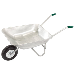 A Draper Galvanised Wheelbarrow, 65L - GWB, featuring one black pneumatic tyre, two handles with green grips, and a support stand is shown against a white background.